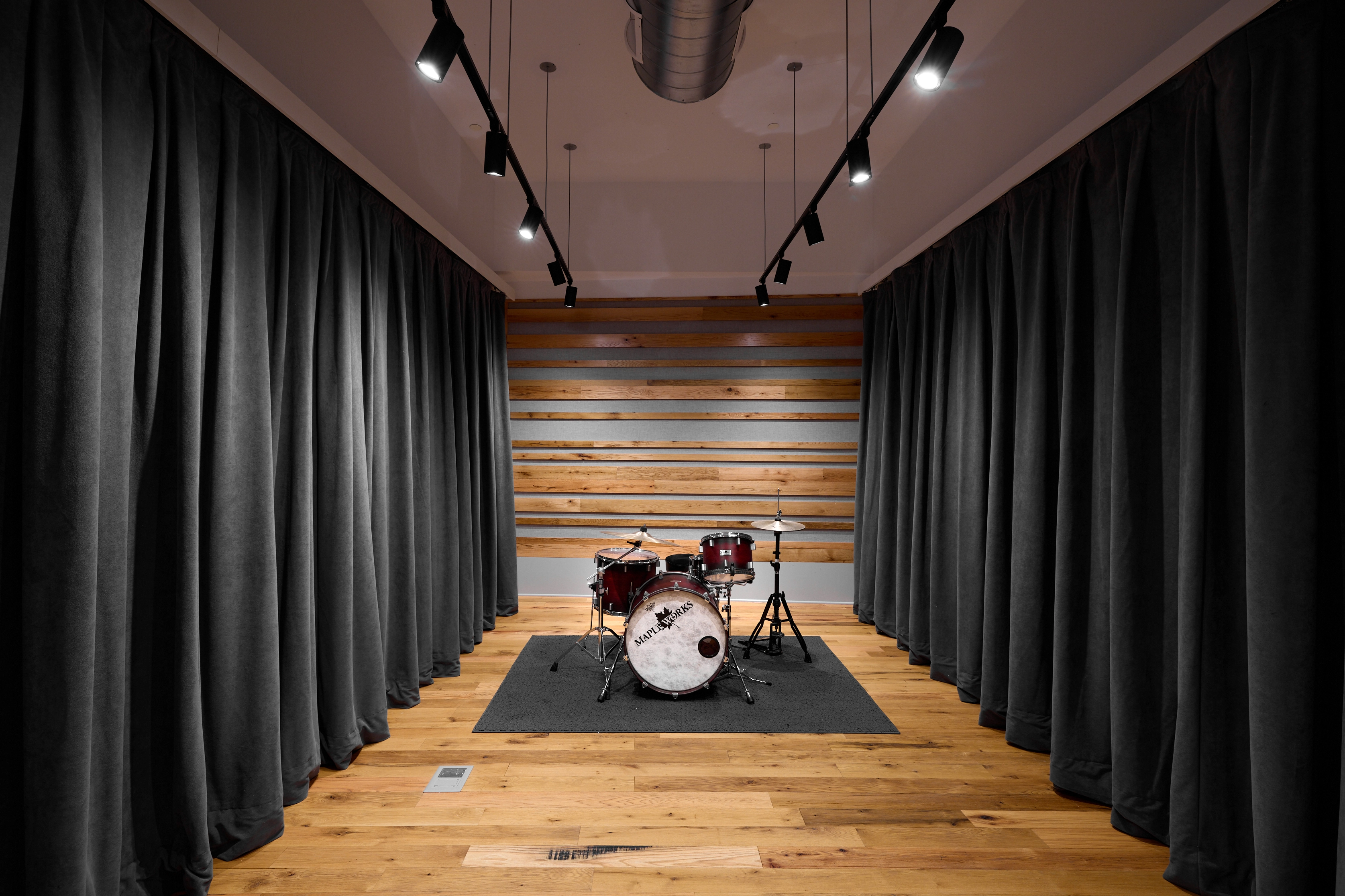 Studio B live room with curtains and a drumset
